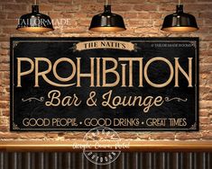 the sign for prohibition bar and lounge is hanging on a brick wall with three lamps above it