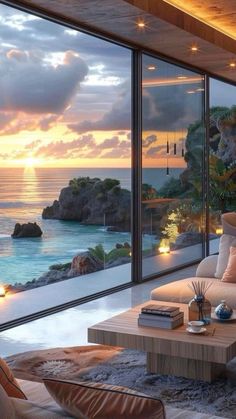 a living room filled with furniture next to a large window overlooking the ocean at sunset