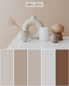 the color scheme is neutral and beige with some white vases in front of it