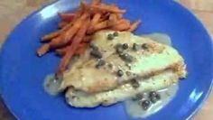 a blue plate topped with chicken, carrots and gravy next to a pile of fries