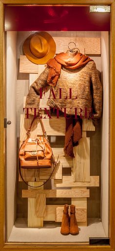 a display case with hats and purses in it