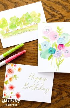 three cards with watercolor flowers on them