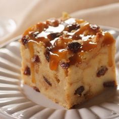 a piece of cake sitting on top of a white plate with caramel toppings