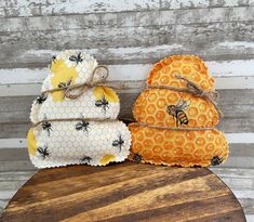 three pieces of fabric sitting on top of a wooden table