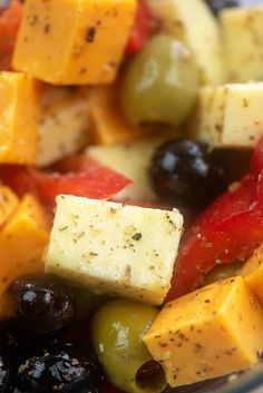 a bowl filled with assorted fruits and cheese