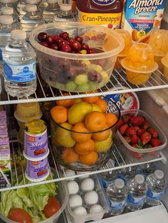 an open refrigerator filled with lots of fresh fruits and vegetables next to eggs, milk, yogurt, fruit juice, and water