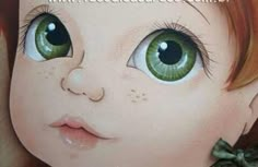 a close up of a child's face with green eyes