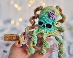 a crocheted octopus is in a bottle with a corkscrew on it