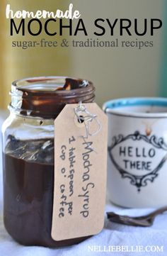 homemade mocha syrup in a glass jar and two mugs with labels on them