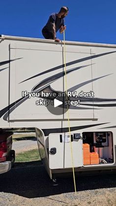 a man standing on top of an rv