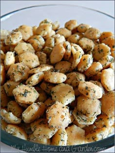 a glass bowl filled with potatoes covered in seasoning