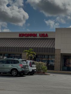 an empty parking lot in front of a koopin usa store on a cloudy day