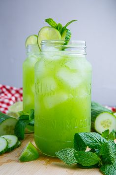 two mason jars filled with cucumber and limeade