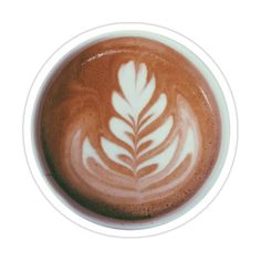 a cappuccino with white leaves on it