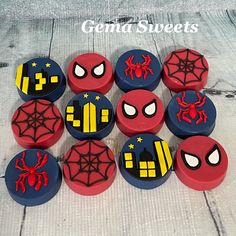 twelve spiderman themed candy boxes on a wooden table