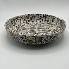 a black and white bowl with dots on it