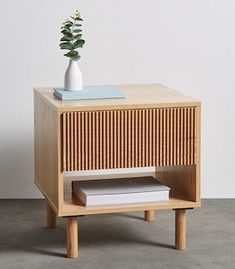 a wooden side table with a plant on top