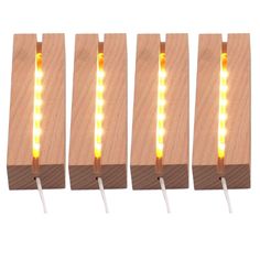 four pieces of wood with yellow lights on each side and one piece in the middle