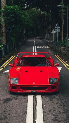 a red sports car is parked on the street