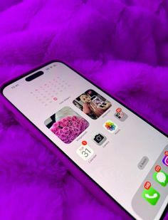 an iphone on a purple blanket with the screen showing icons for different things to see