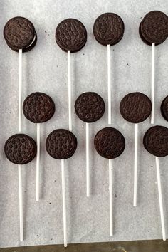 oreo cookies and white sticks are arranged on a sheet of paper