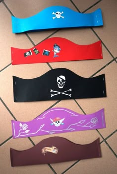 four different colored pirate headbands with skull and crossbones on them