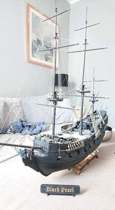 a model ship sitting on top of a bed