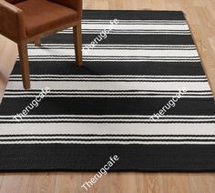 a black and white striped rug with a chair