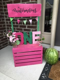 a sign that says watermelon's one on top of a wooden crate