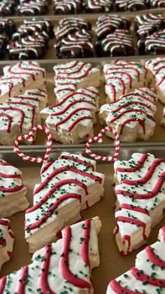 many decorated cookies are lined up on a baking sheet and ready to be baked in the oven