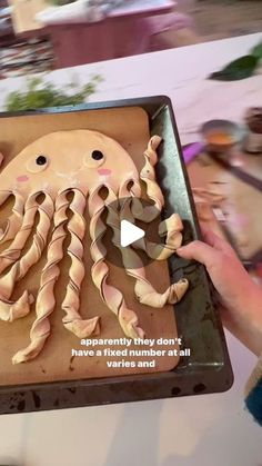 someone is holding up a cake with an octopus on it