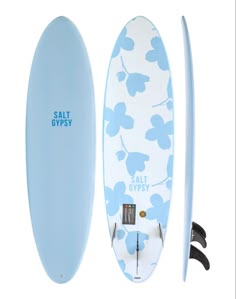 a surfboard with blue flowers on it next to a white board and black handles