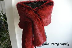 a red fur coat hanging on a rack