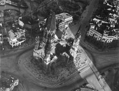 an aerial view of a large building with towers