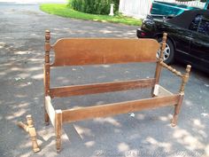 an old wooden bed frame sitting in the street