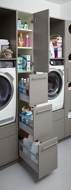 a washer and dryer in a room with shelves on the wall next to each other