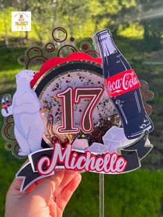 a person holding up a clock with coca - cola and ice cream on it's face