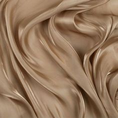 a close up view of a brown silk fabric with wavy lines in the center and bottom