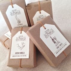 four brown paper packages with tags on them