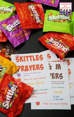 several packets of skittles are on the table