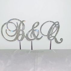 two monogrammed cake toppers with the initials on them