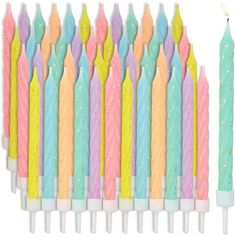 many colorful candles are lined up together