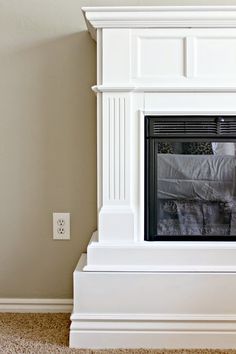 a white fireplace with a blanket on it