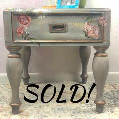 an old dresser with flowers painted on it and the word sold written in front of it