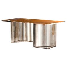 two tables made out of metal bars on top of each other, one with a wooden table