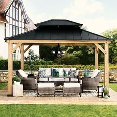 an outdoor living area with couches and tables