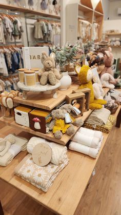 several stuffed animals are on display in the store's clothing and baby goods section