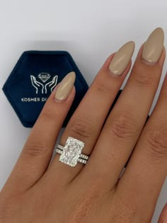 a woman's hand with an engagement ring on it