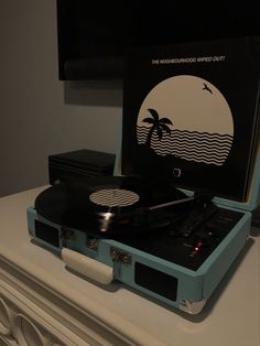 an old record player sitting on top of a dresser