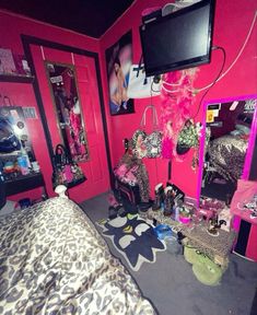 a bedroom with pink walls and leopard print bedding